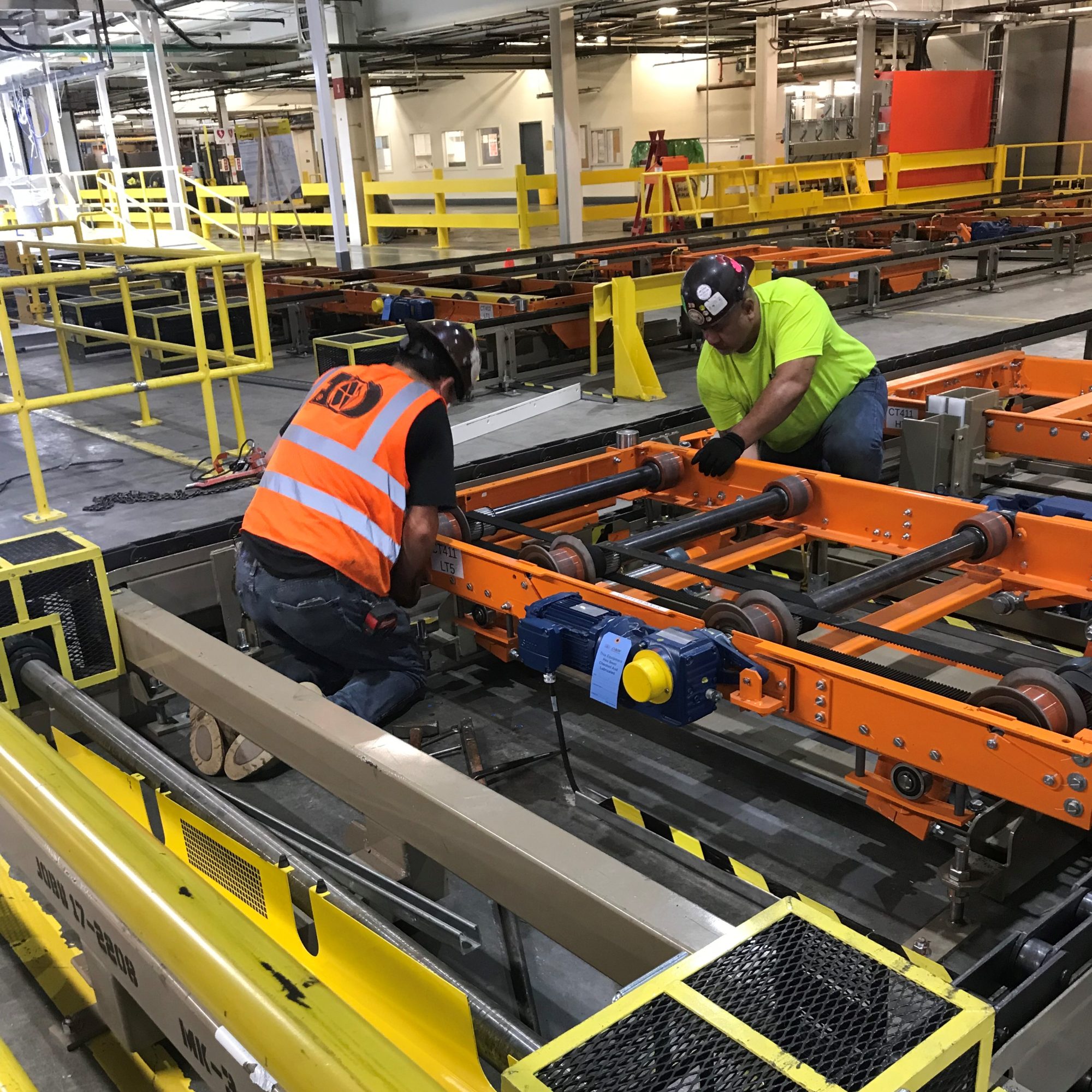 Workers fixing conveyor