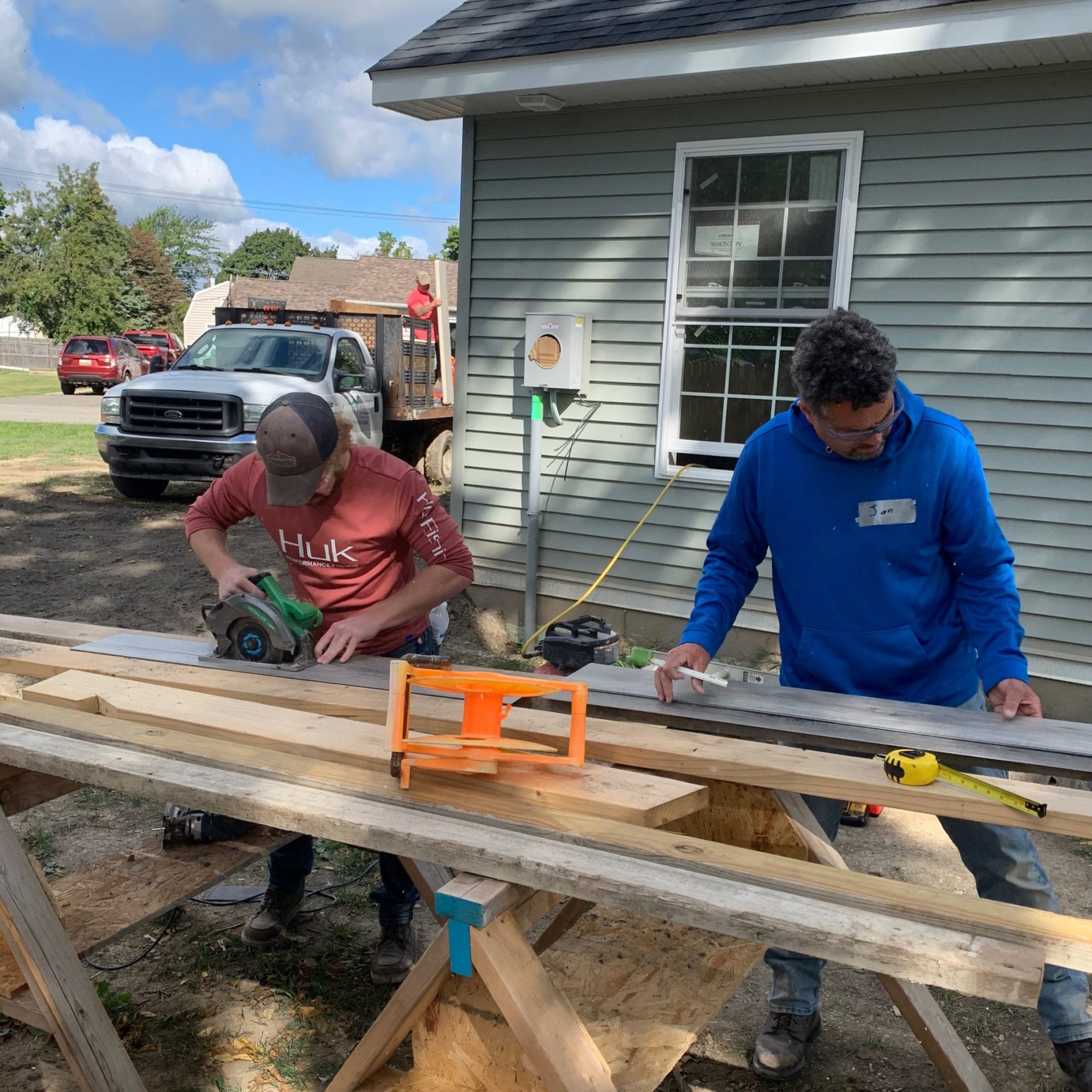 Two people measuring wood